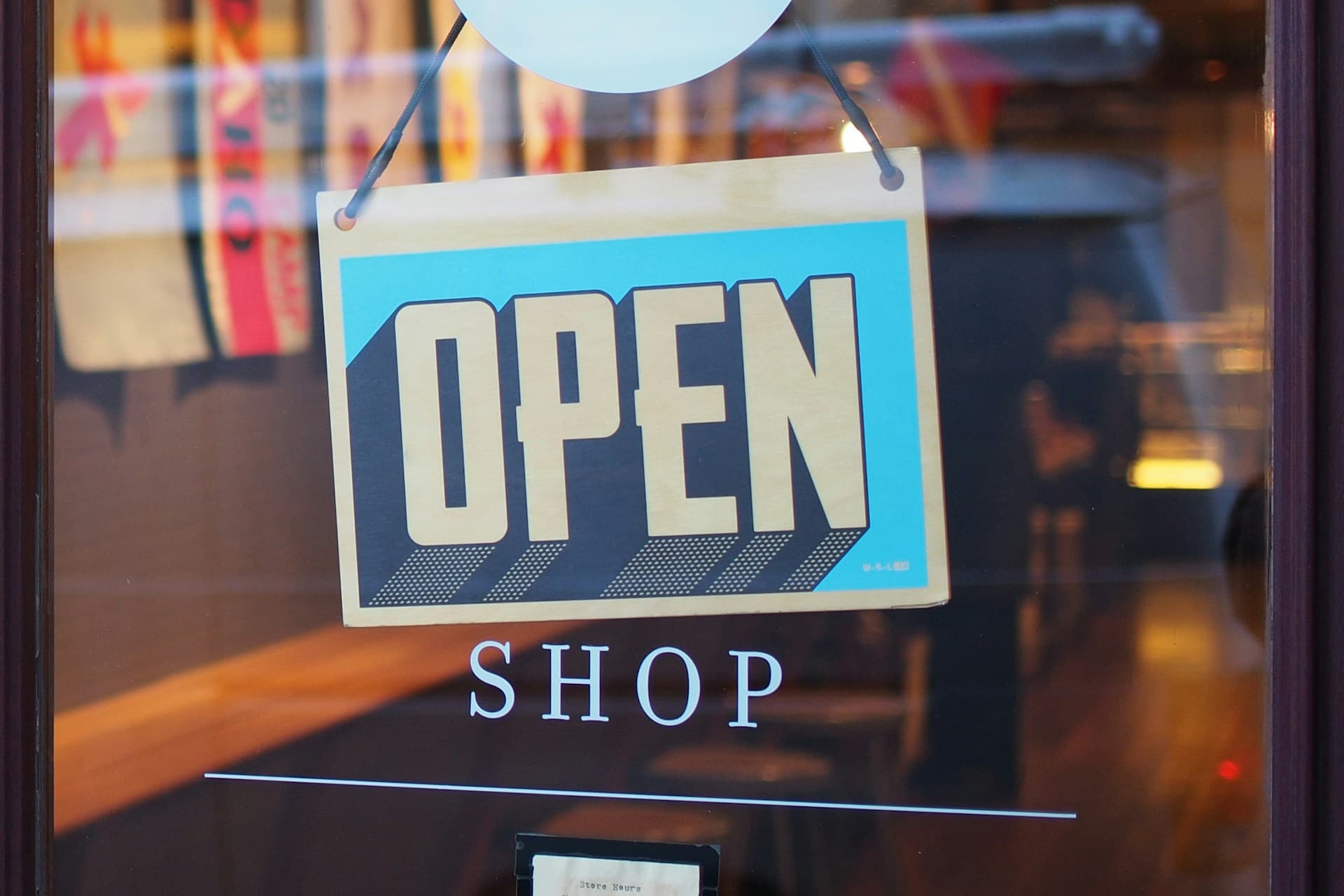 An "Open" sign hanging in a store window