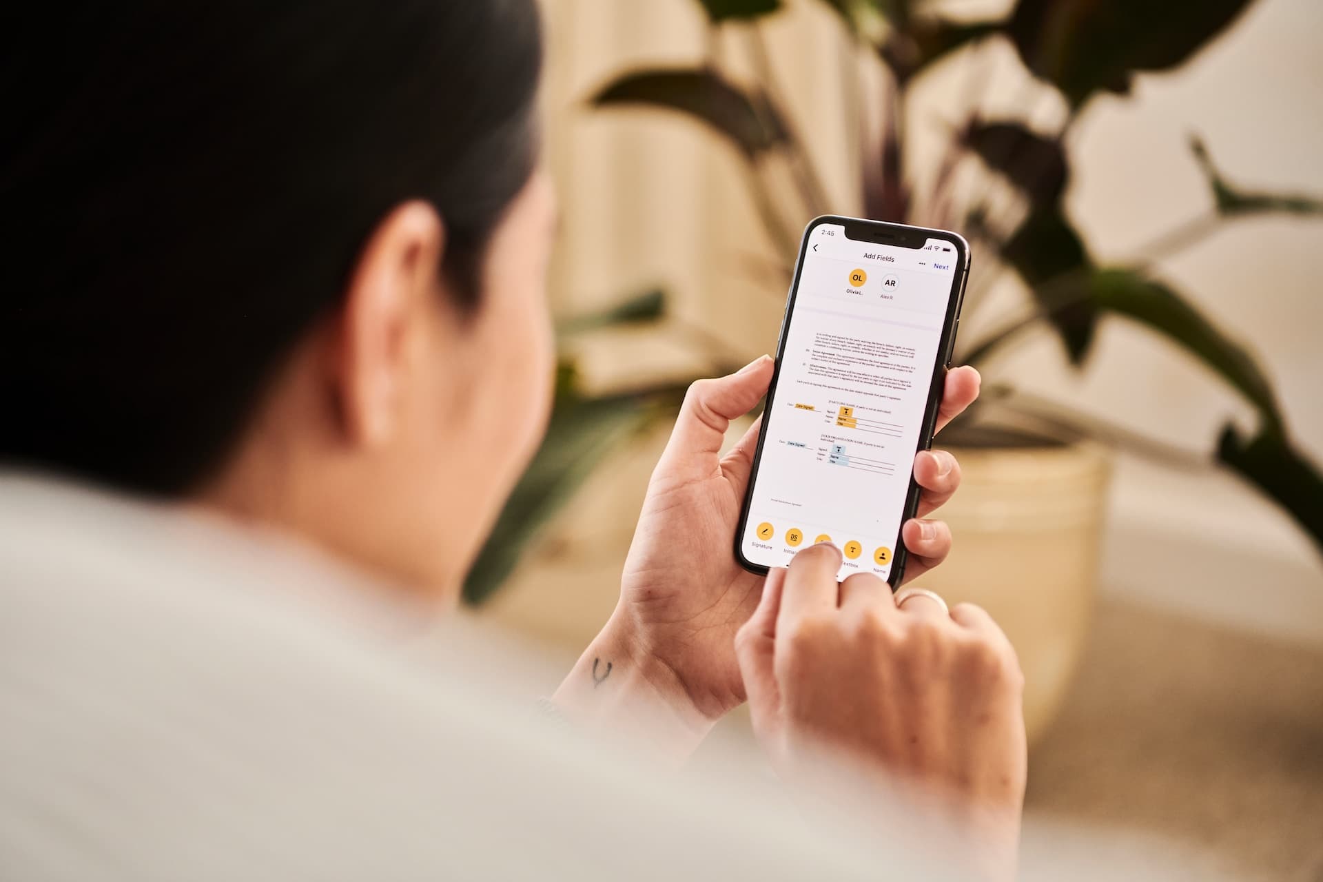 A man signing a job contract on his phone