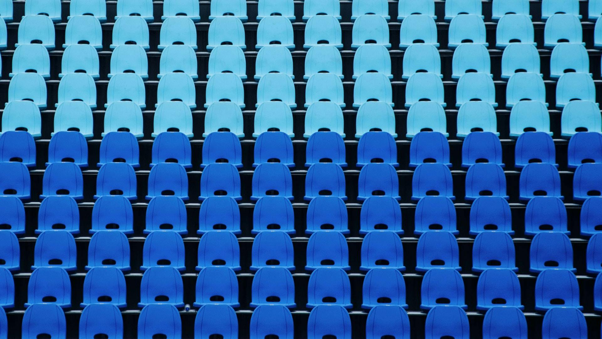 Several rows of blue bleachers