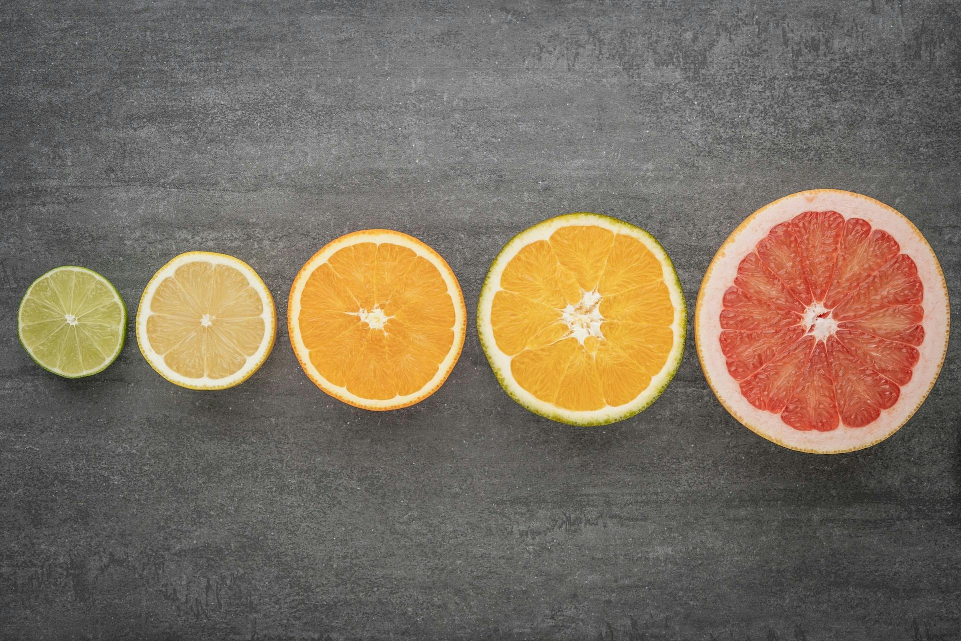 Multiple different types of citrus fruit in a horizontal line